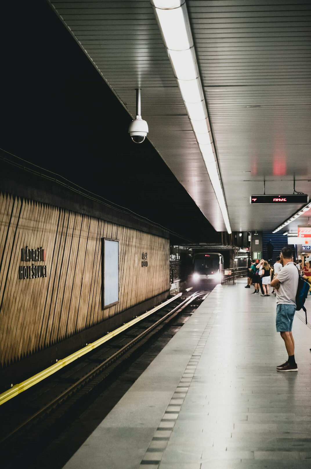 woman checking watch at station