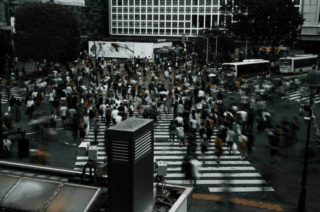 people waiting at city crosswalk