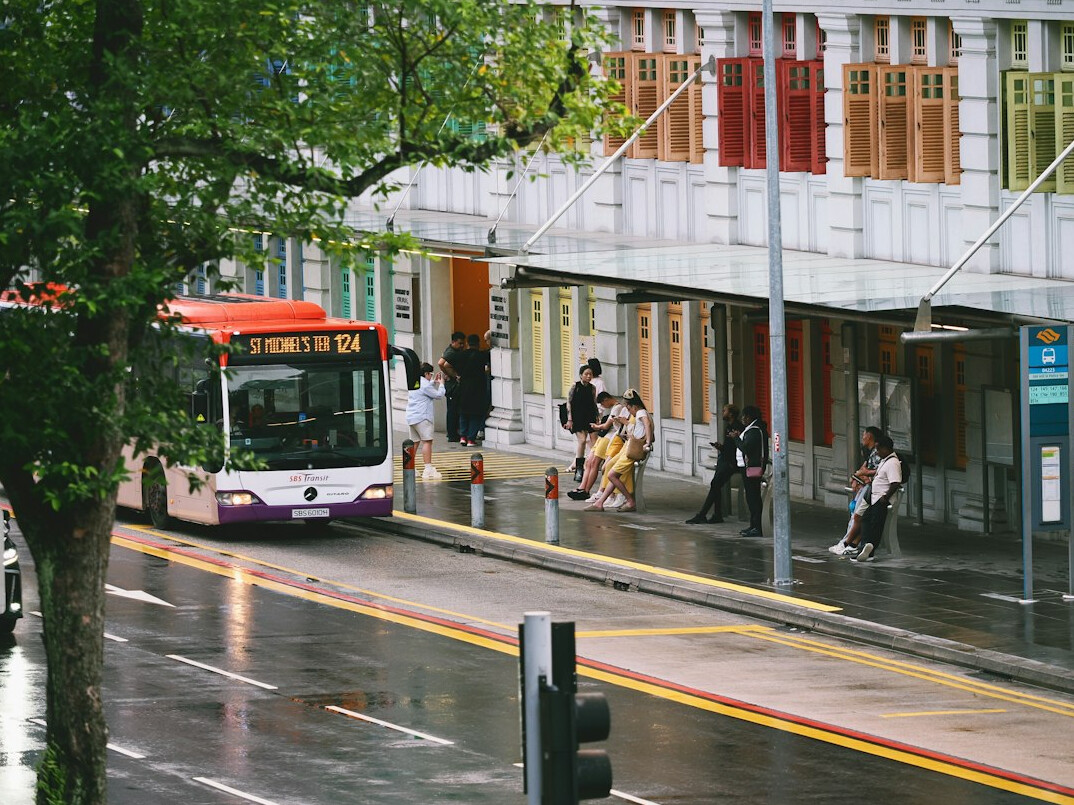 people waiting at city bus stop