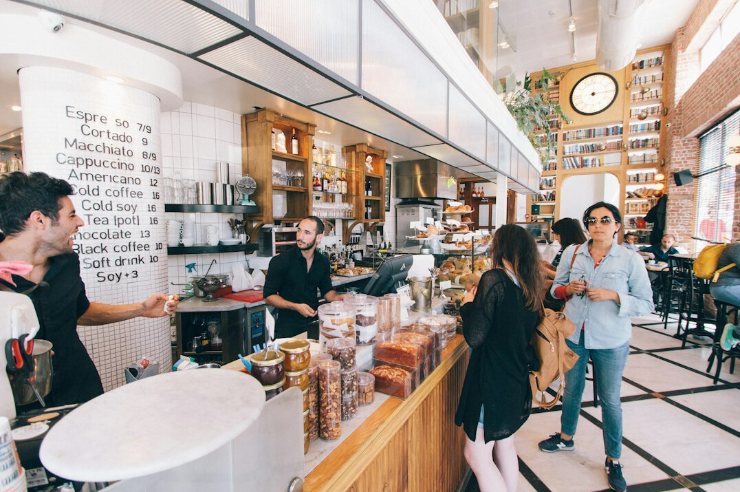 Customers standing in line inside a coffee shop
