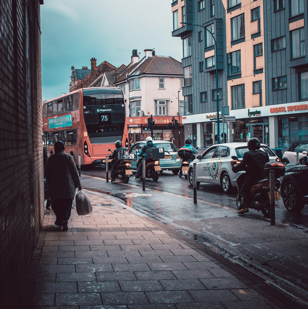 person checking phone on busy street